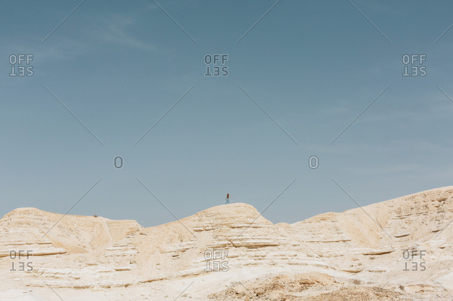 Woman hiking in Nitzana Park Rock formation, in Negev Desert Israel