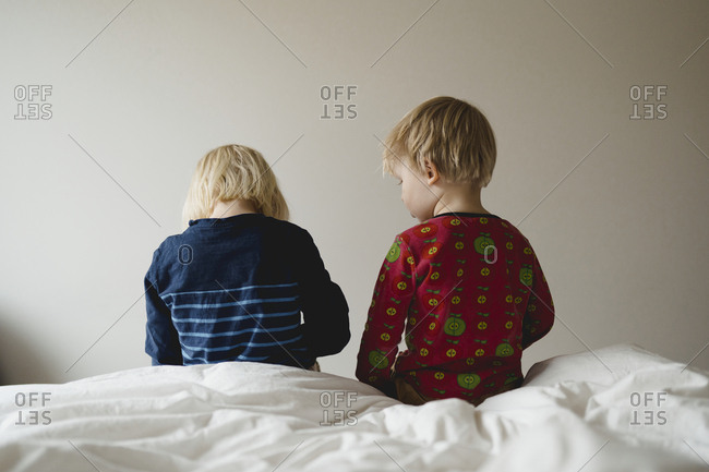 Kids sitting on bed