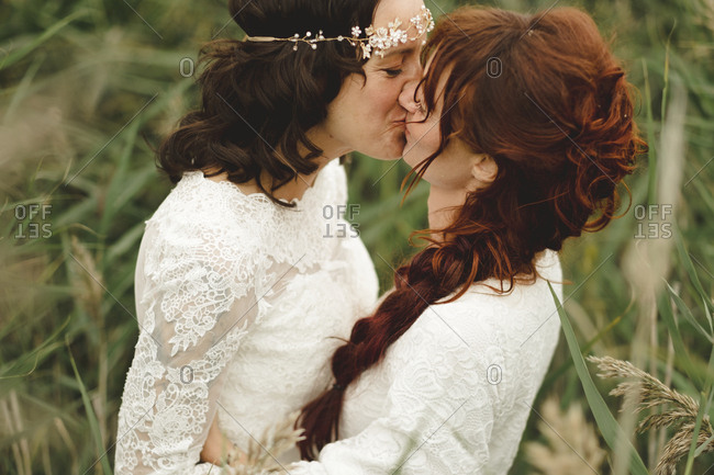 Brides kissing outdoors - Offset Collection