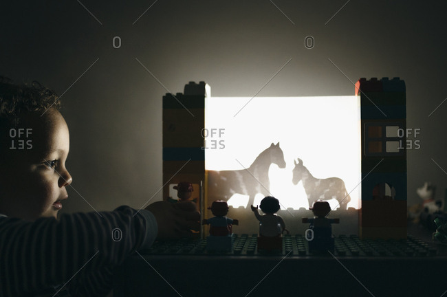 Child plays with shadow theather
