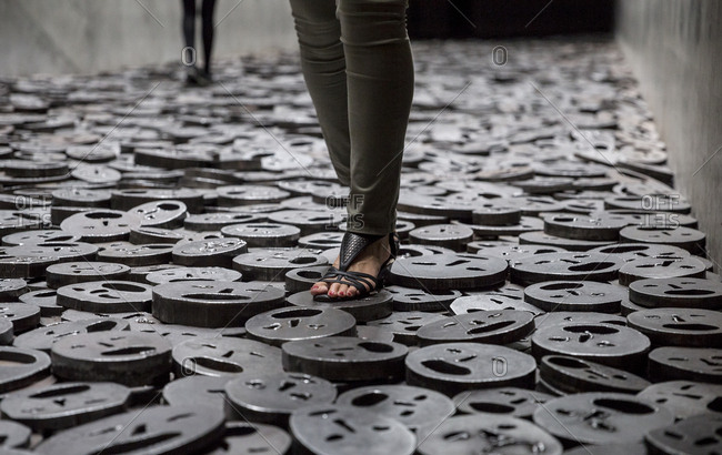 People visiting the Fallen Leaves installation in the Memory Void at the Jewish Museum, Berlin, Germany.