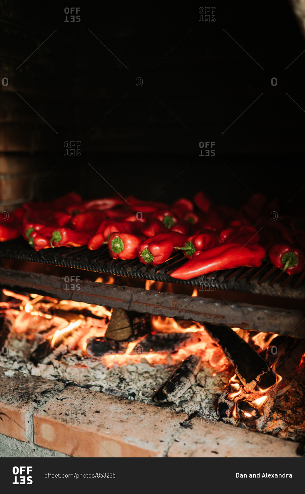 Red peppers cooking in a wood fire oven