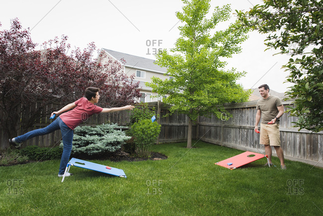 Children in underwear playing stickball in backyard stock photo