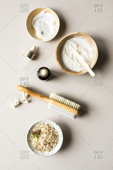 Overhead view of 3 bowls containing cream, powder, and salt for beauty products