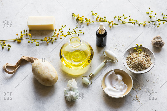Collection of skin care products and yellow flowers