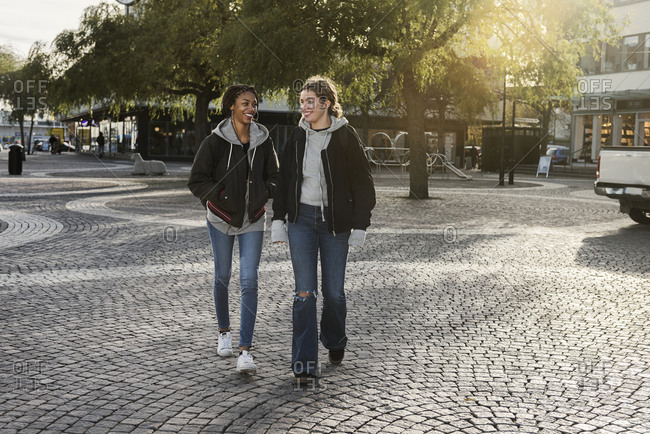 Teenage girls walking on cobblestone