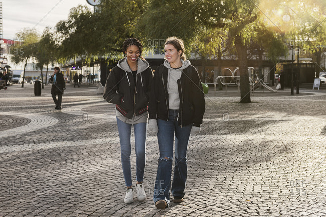 Teenage girls walking on cobblestone