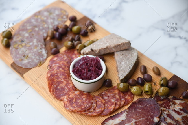 Charcuterie board appetizer on light surface