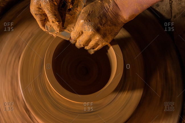 Hands making ceramic art