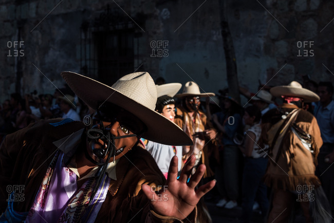 July 28, 2019: Masked performers parade in the Guelaguetza festival in Oaxaca, Mexico