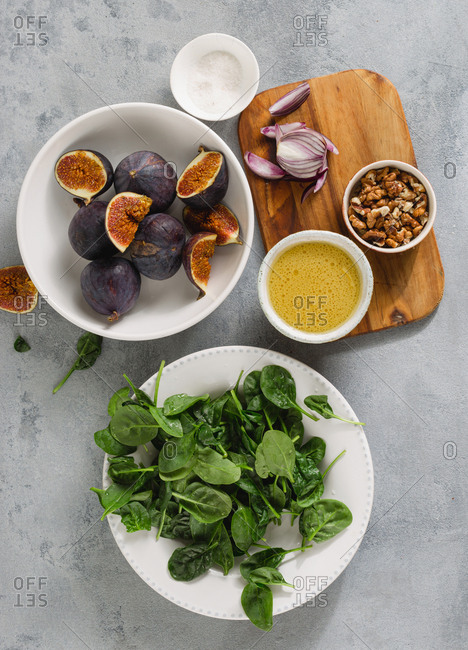 Ingredients for cooking salad with figs, spinach, walnuts with mustard honey sauce top view