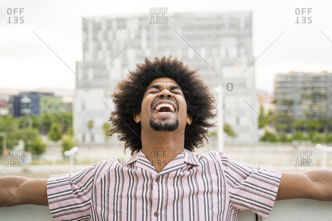 Young hipster on viewpoint- city in the background