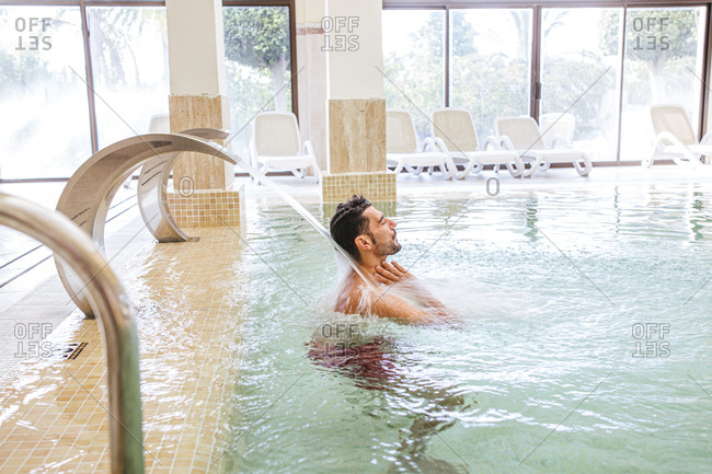 Man relaxing in swimming pool of a spa