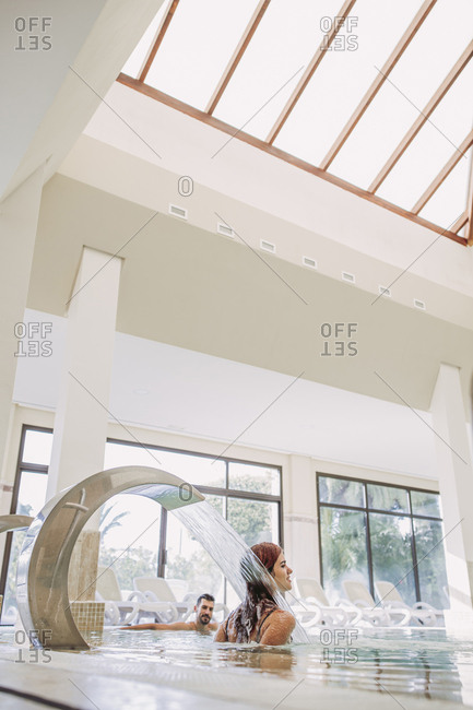 Couple relaxing in swimming pool of a spa