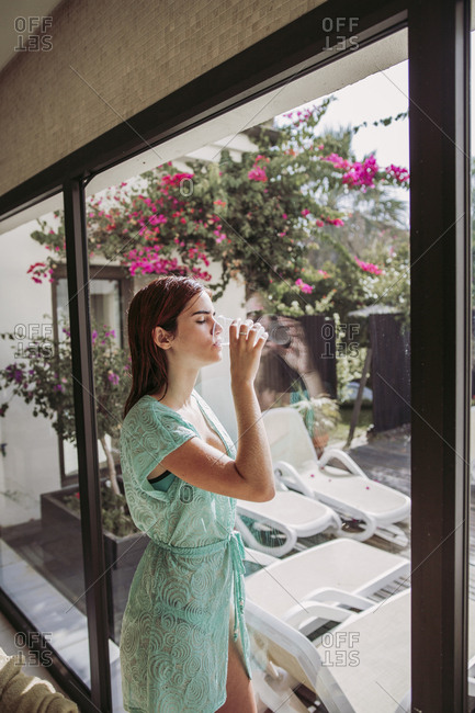 Young woman drinking water in a spa