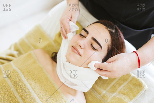 Young woman receiving facial beauty treatment in a spa