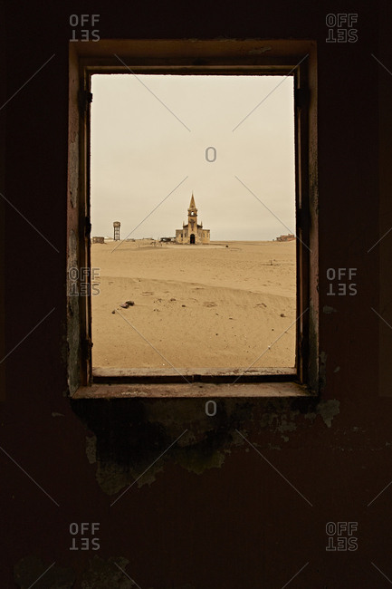 View through a window of the church at the abandoned village of Ilha dos Tigres- Angola.