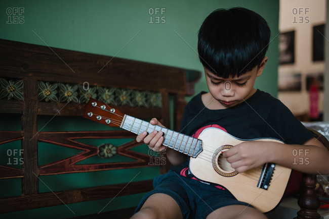 Asian boy playing guitar