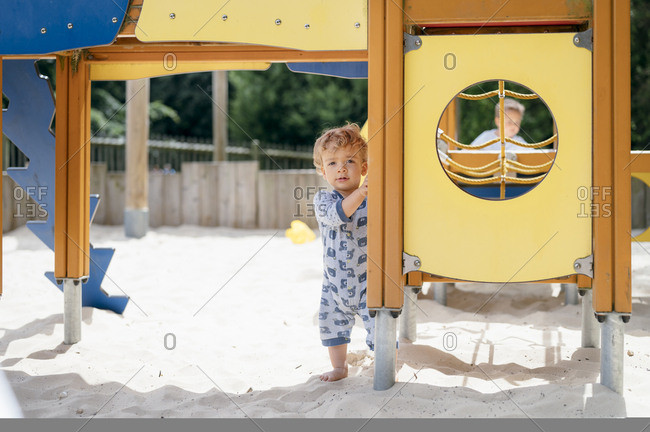 Children play in sandpit on sunny day