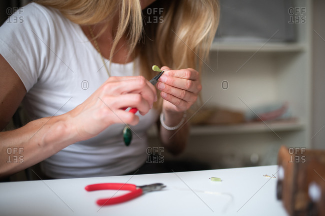 Close up of a woman making jewelry