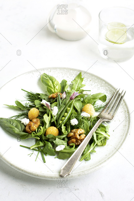 Healthy salad with arugula and coconut vinaigrette served on a plate