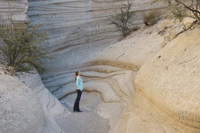 Hiker admiring a sandstone canyon in Kasha-Katuwe Tent Rocks National Monument, New Mexico