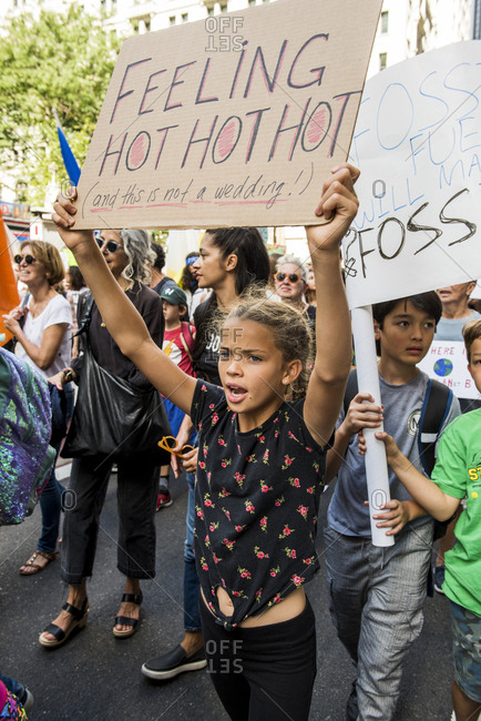 New York City, New York - September 20, 2019: Kids holding signs and chanting while marching at the Global Climate Strike