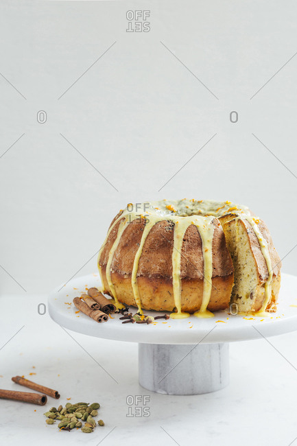 Delicious orange spice cake on marble surface