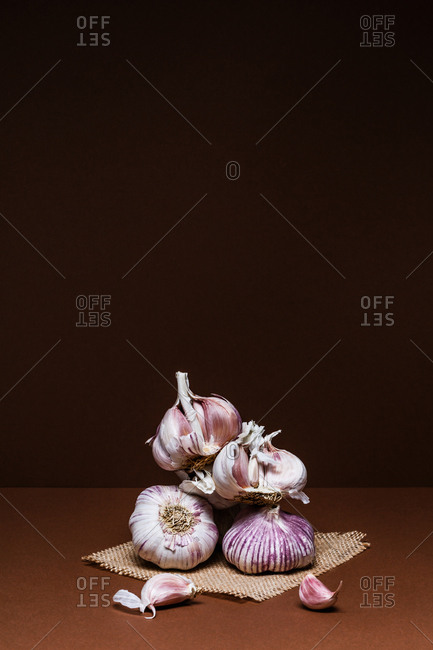 Garlic heads on brown background