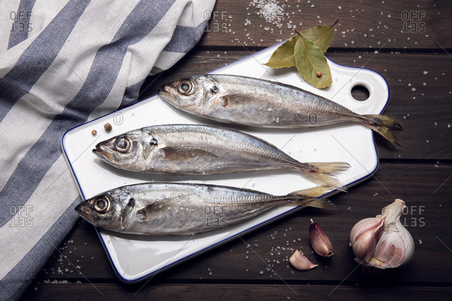 Fresh mackerel fish on cutting board ready to cook. raw seafood