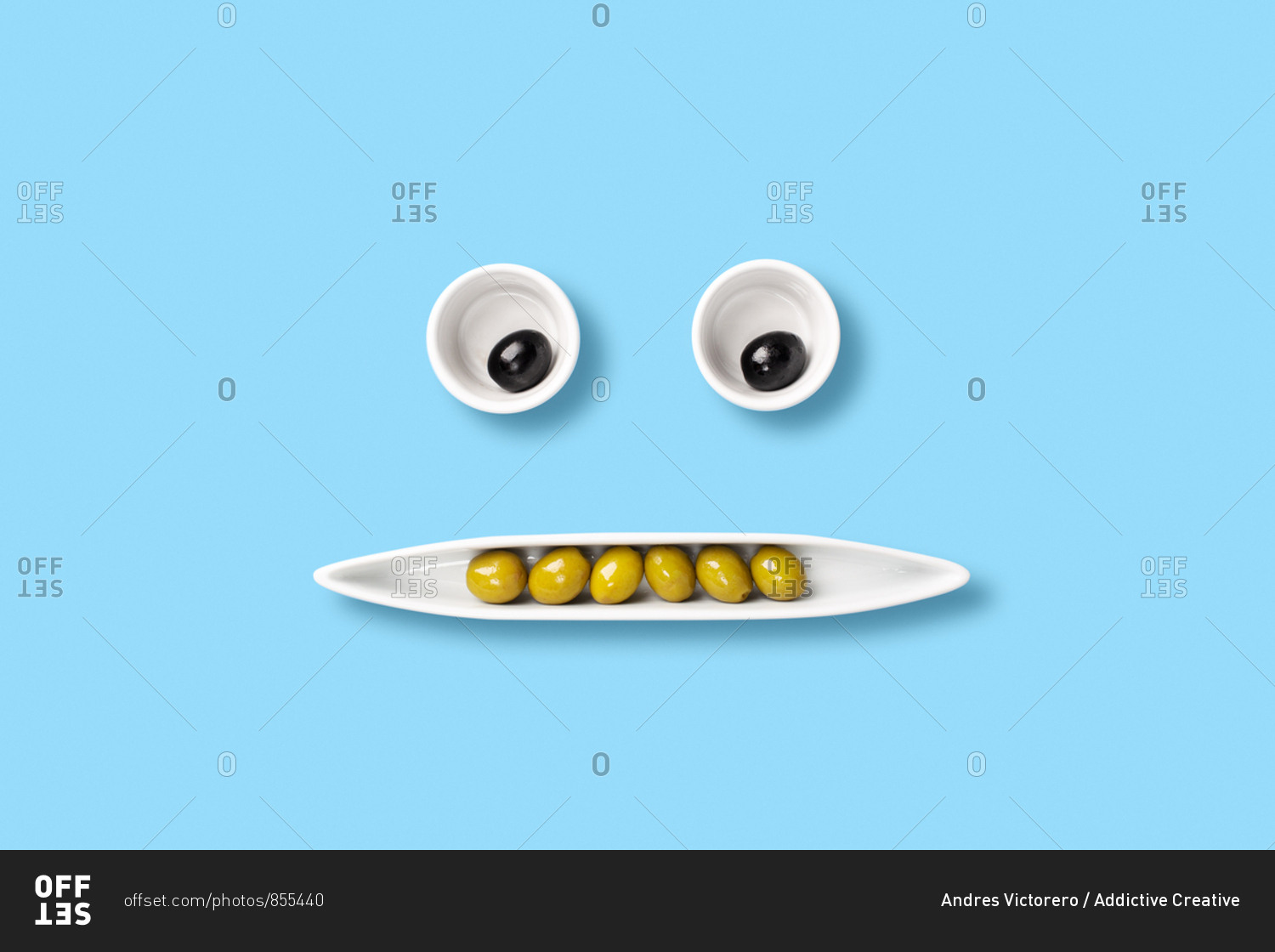Olives on tray forming a face. funny composition of food. pop art