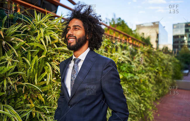 Confident ethnic businessman looking away