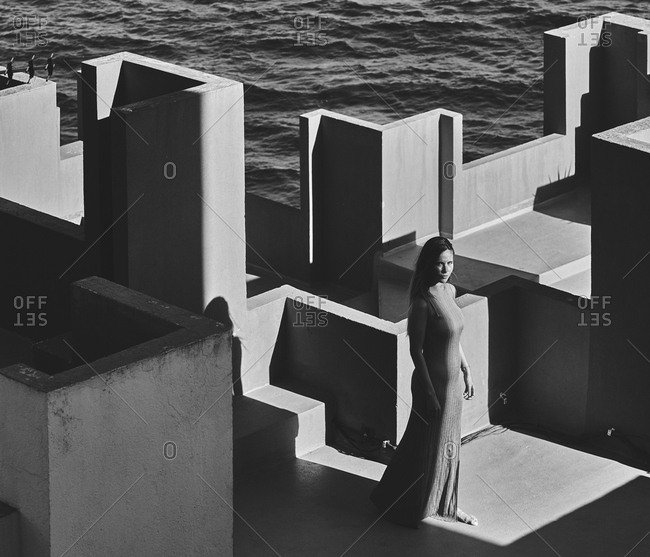 From above of woman in blue fur dress on the roof of a building