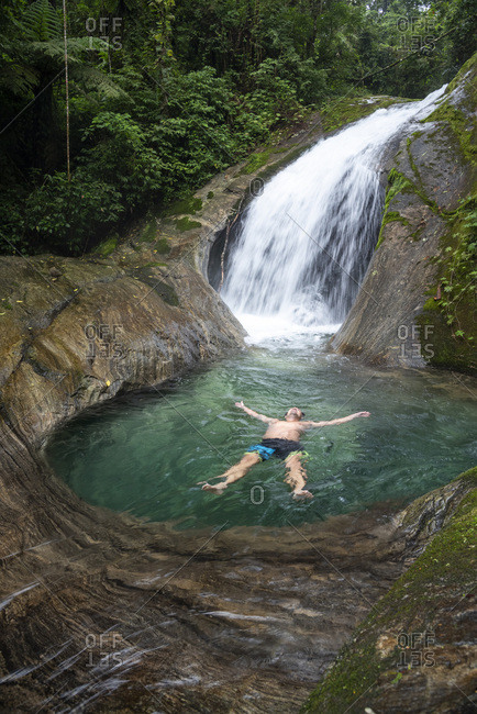 Serrinha, Rio de Janeiro, Brazil - May 10, 2019: Beautiful landscape of man floating on crystal clear water river