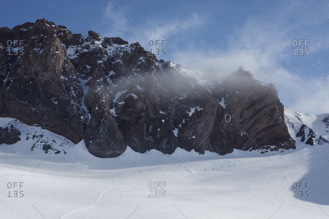 A climbing rope team ascends the trail above camp muir on mt rainier
