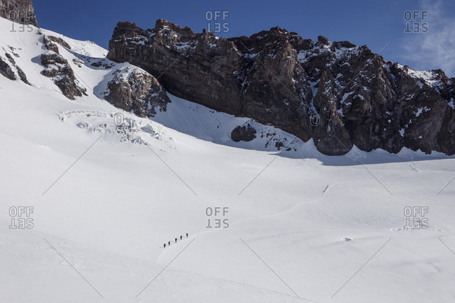 Climbing teams descend a trail above camp muir on mount rainier