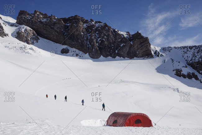 Climbers descend a trail to camp muir on mount rainier, washington