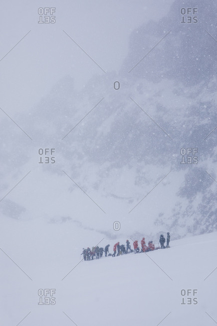 A group of climbers rests during a may blizzard on mount rainier