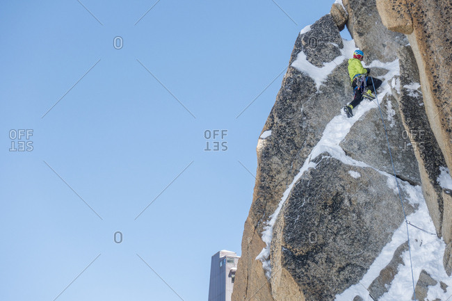 An alpinist runs out steep mixed terrain on the aiguille du midi