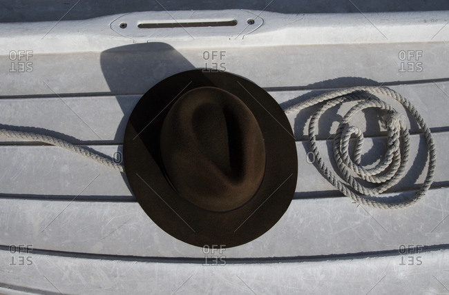 Weathered boat planks with brown hat and nautical rope