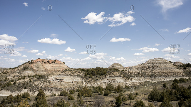 Rock formations stand prominent on the grasslands of north dakota.