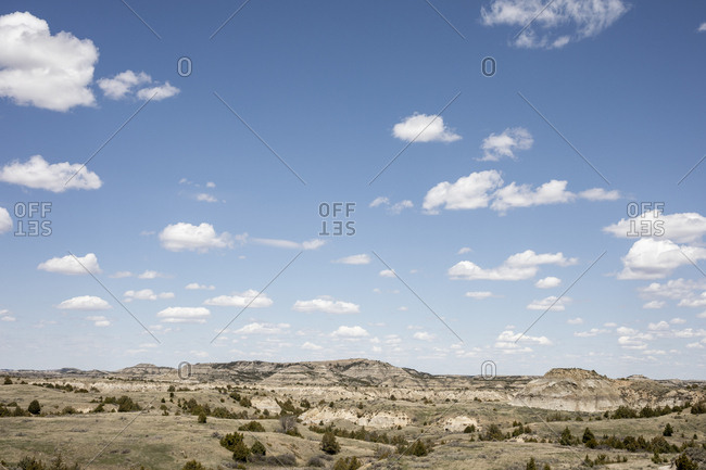 Rock formations stand prominent on the grasslands of north dakota.