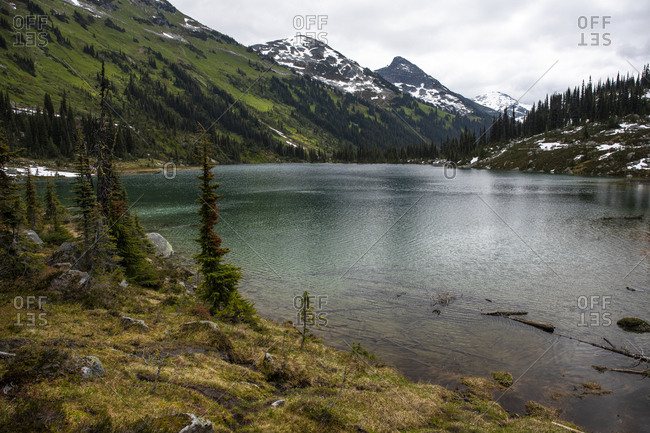 Scenic view of alpine lake in mountains with clouds in canada.