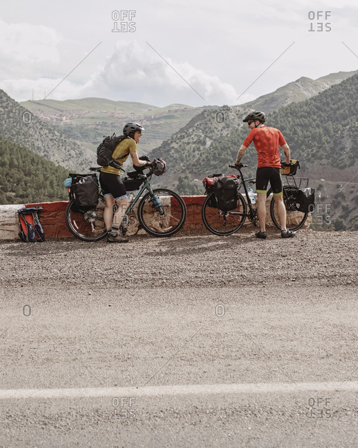 Morocco, Marrakesh-Safi, Asni - April 2, 2019: A couple of bike packers take a break while cycling through morocco.
