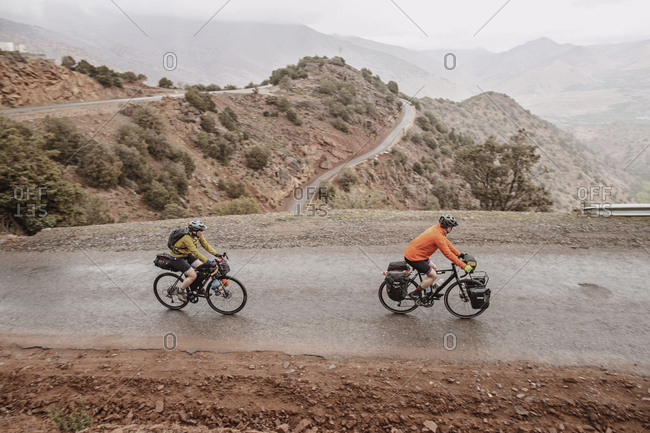 Morocco, Souss-Massa - April 4, 2019: A couple of cyclists biking on the hairpin tizi n test pass, morocco