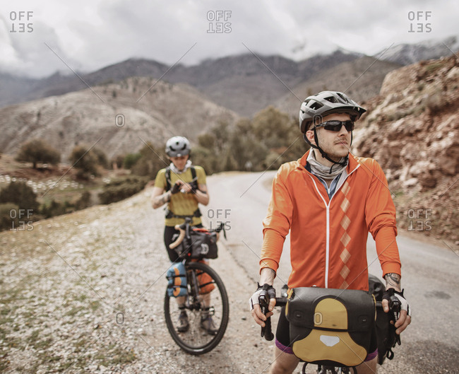 Morocco, Souss-Massa - April 4, 2019: A male and female cyclist take a break on tizi n test pass, morocco