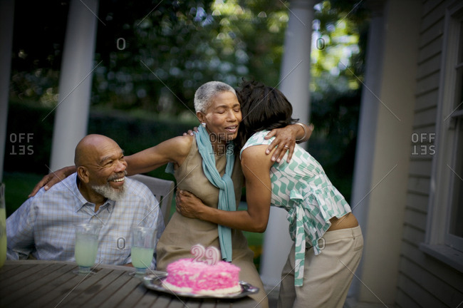 Mature woman hugs her daughter on her wedding anniversary.