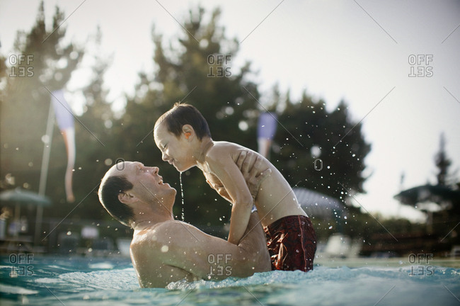 father and son play in pool