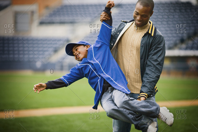 View of a man carrying a small boy.