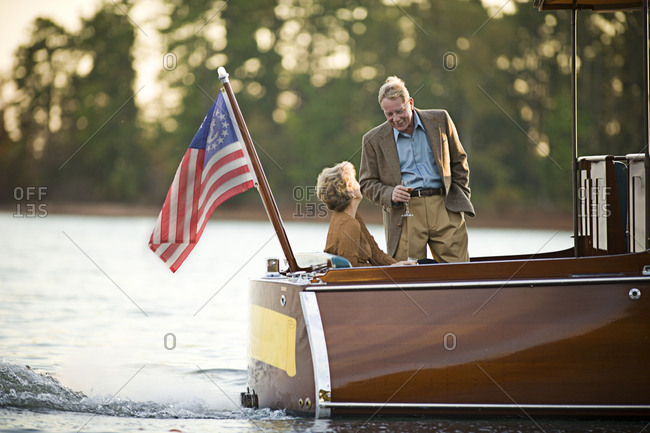 Husband and wife drinking champagne on boat
